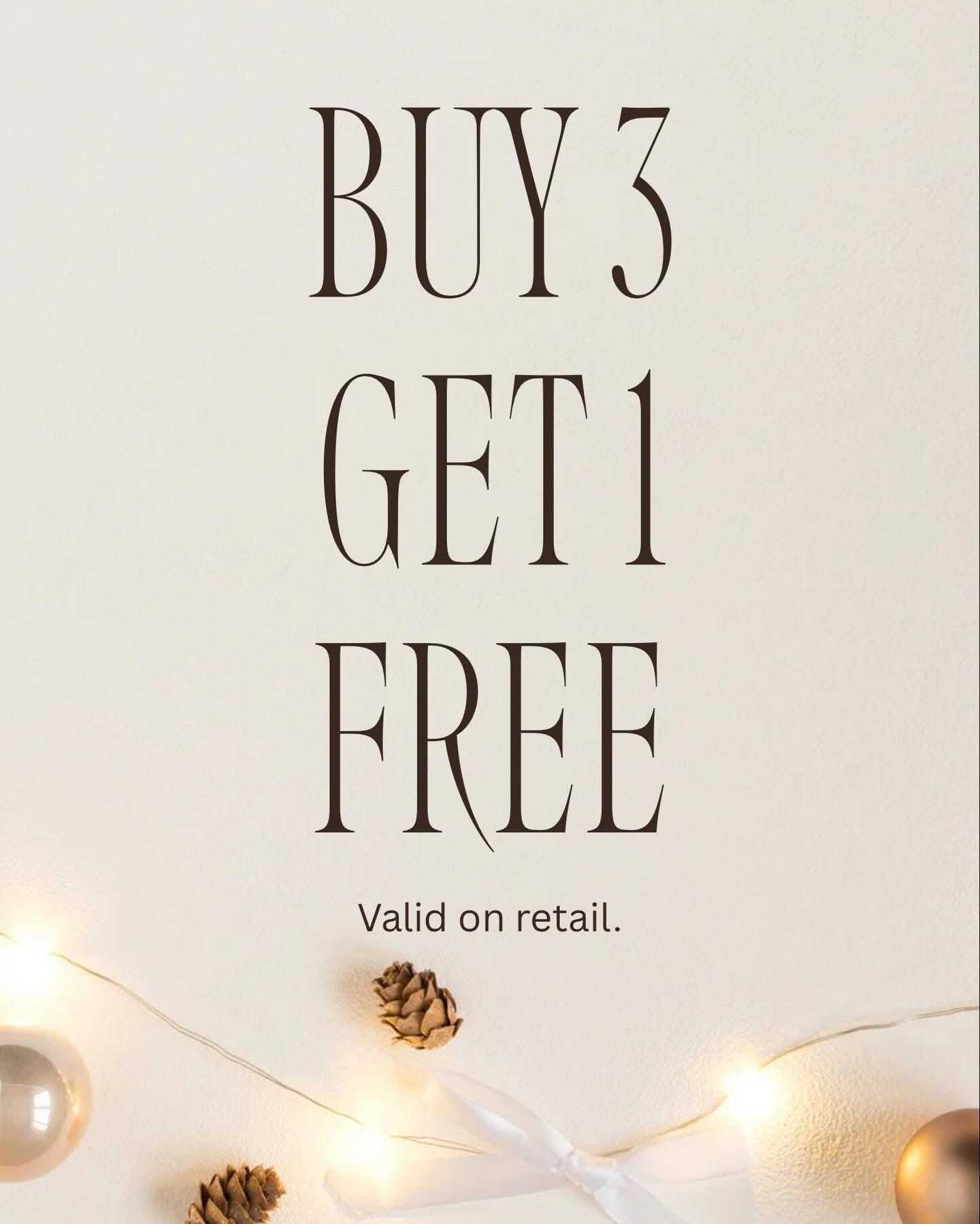 Buy 3 get 1 free offer on retail with lights, ornaments, and pine cones.